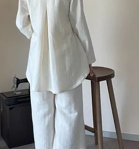 ケープ風の上品な白アウター。立体的なシルエットと大きなボタンが特徴です。